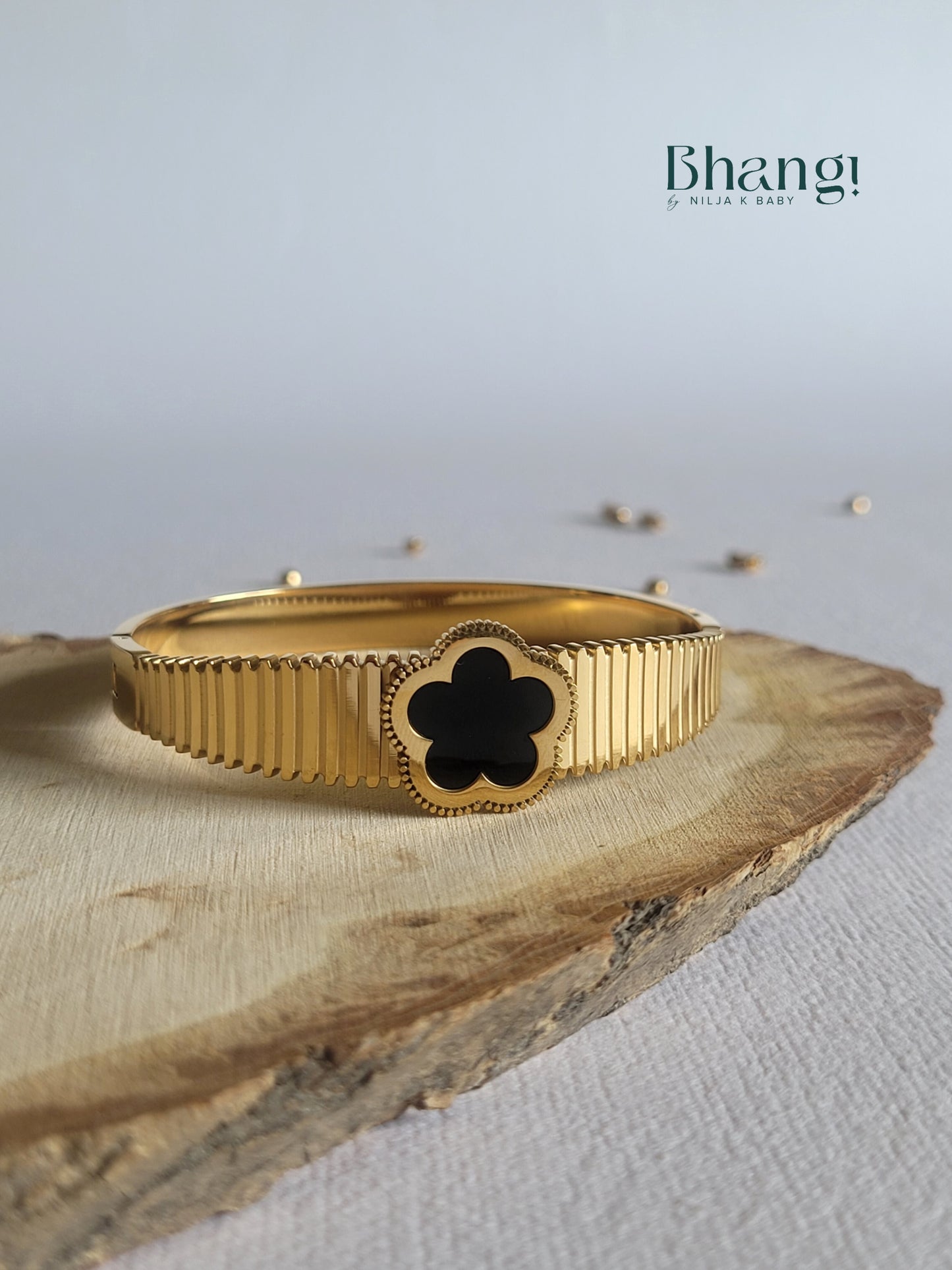 Gold-Tone Bangle with Black Flower