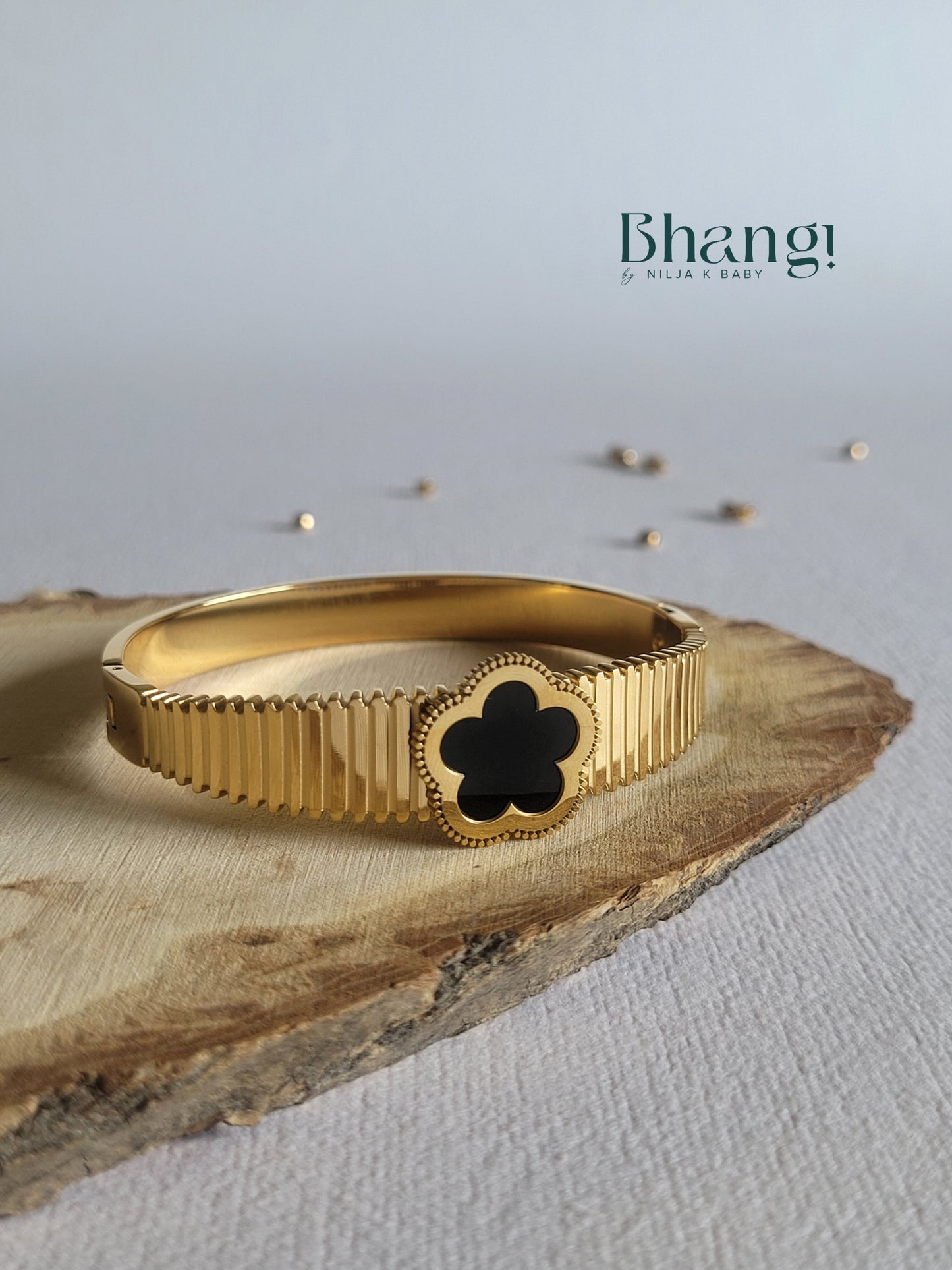 Gold-Tone Bangle with Black Flower